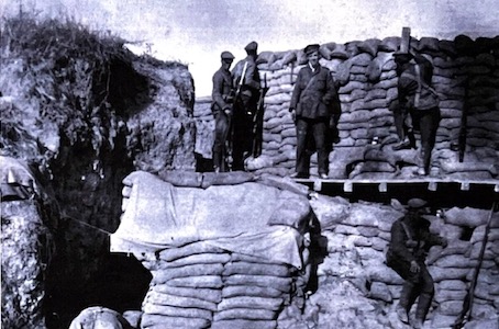 A well established trench. The soldier on the right observes Turkish positions through his periscope